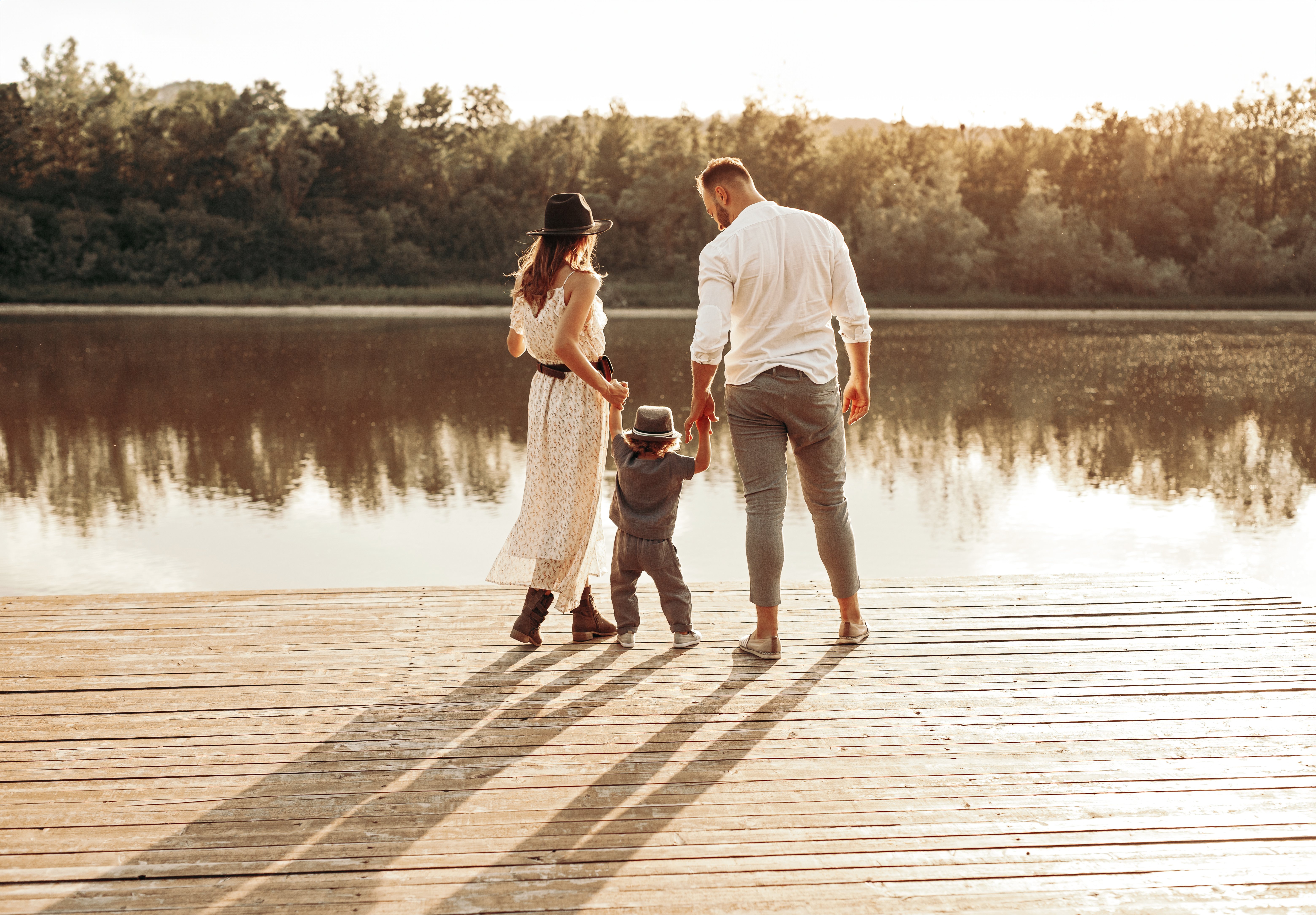 family-standing-on-pier-near-lake-2023-11-27-05-30-56-utc-edit